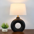 Feng pottery pot table lamp in Japanese style on a wooden desk.