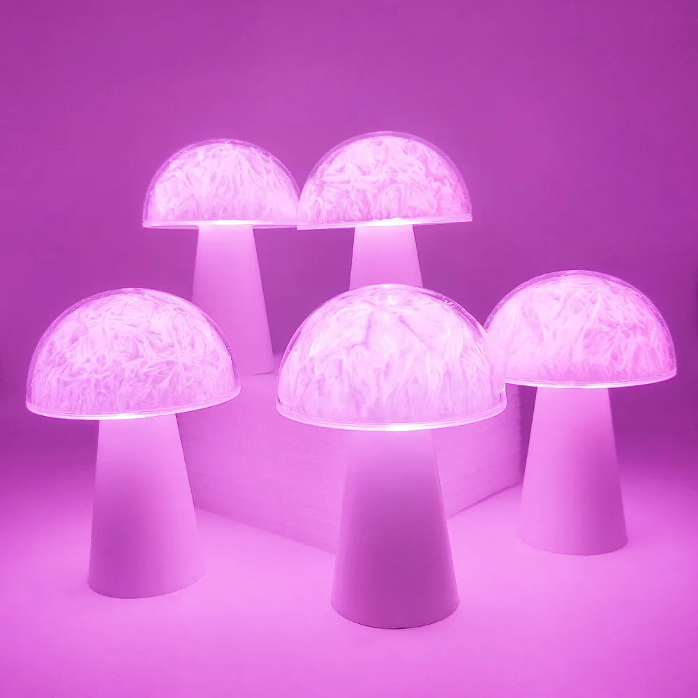Small white mushroom-shaped night light with remote control on a wooden table.