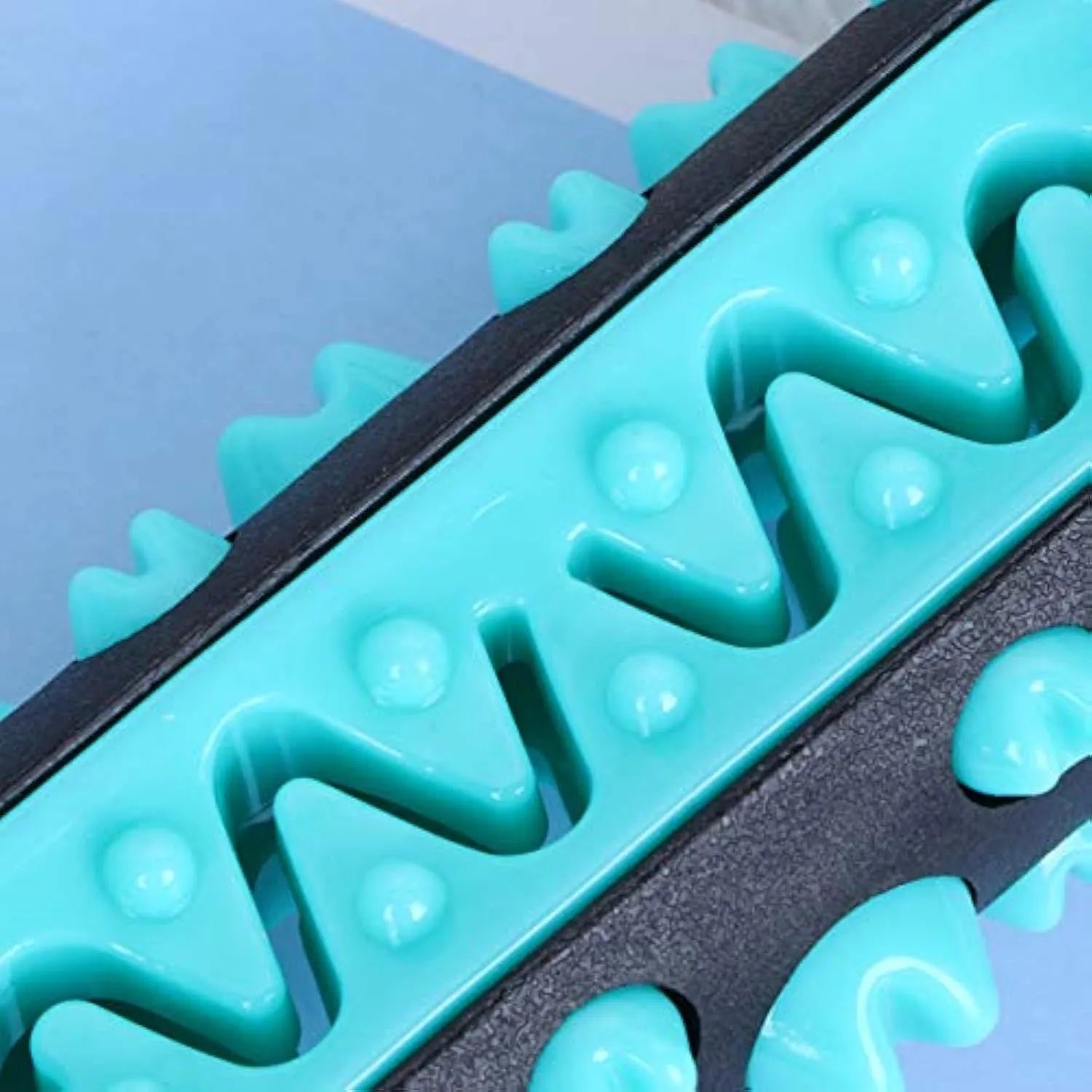 Natural rubber dog dental chew toy in blue, green, yellow, and black blue colours.