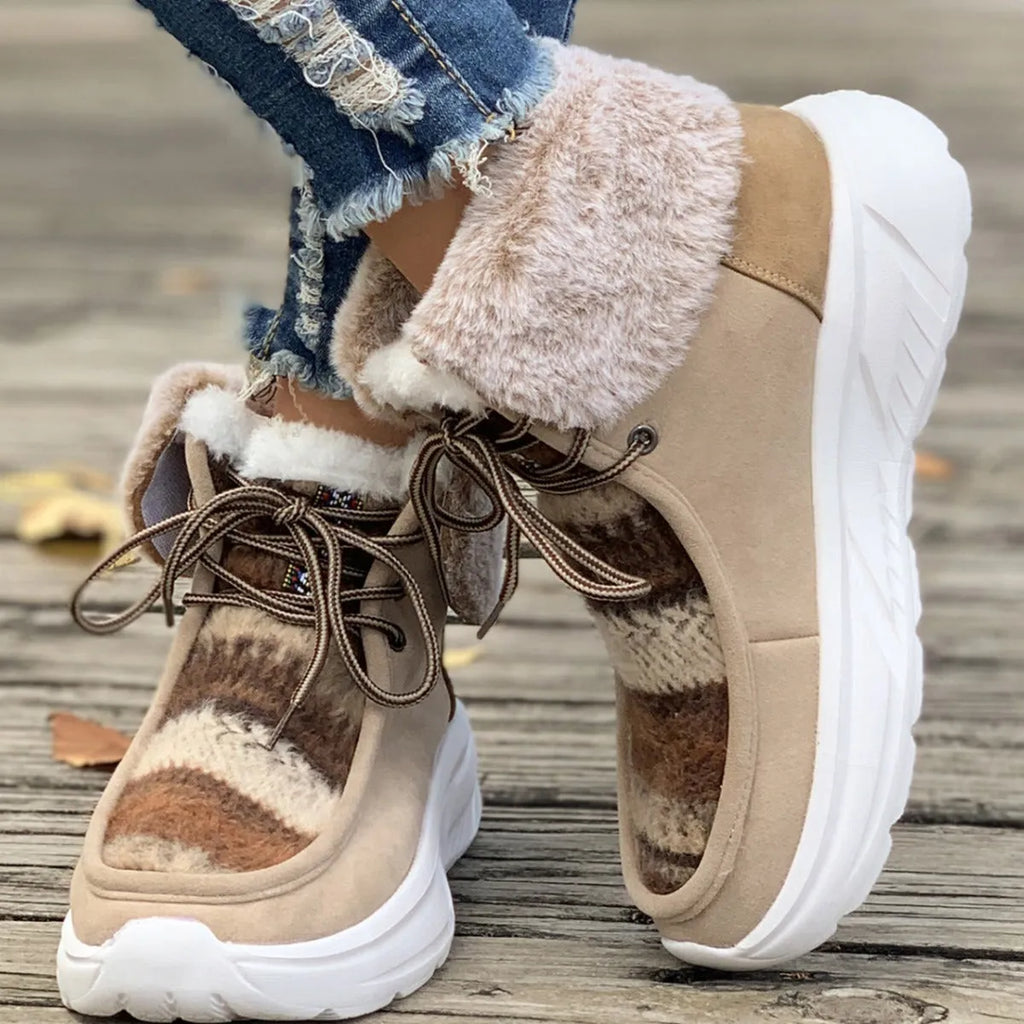 Women's beige lace-up snow boots with fuzzy lining and a thick platform sole on a white background.