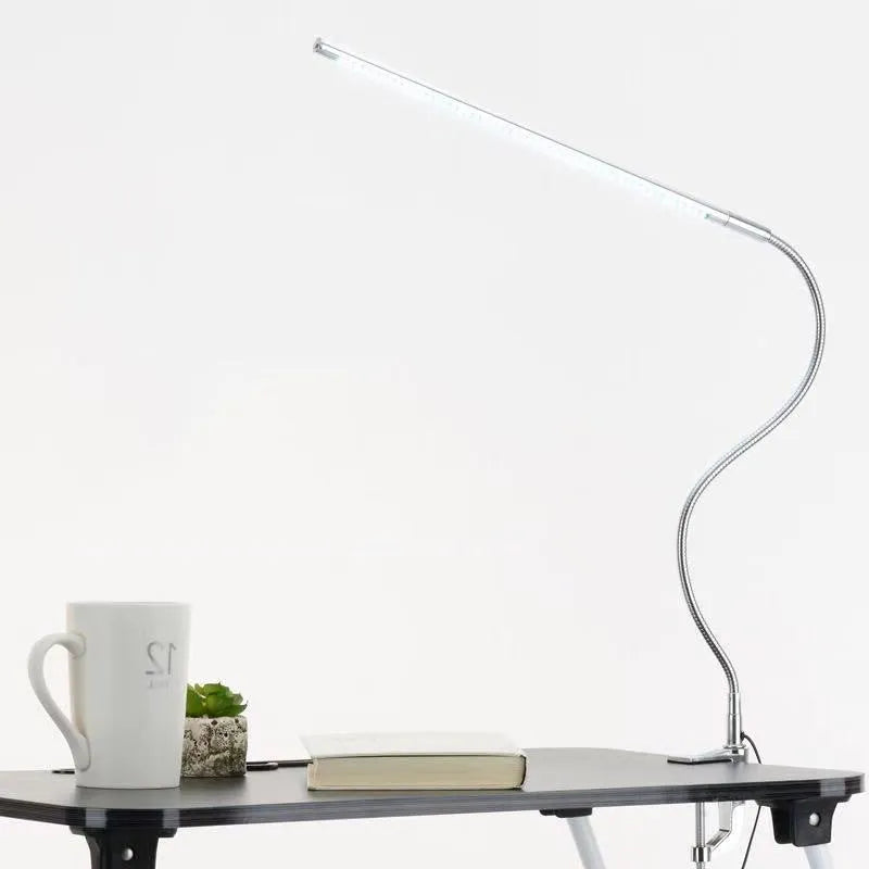 Silver aluminium USB-powered clip-on LED table lamp with a long arm extended, for nail art and detailed tasks.