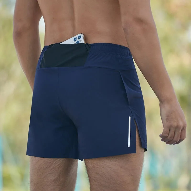 Men's red high-waist off-road running shorts with loose leg design, shown on a model running on a trail.