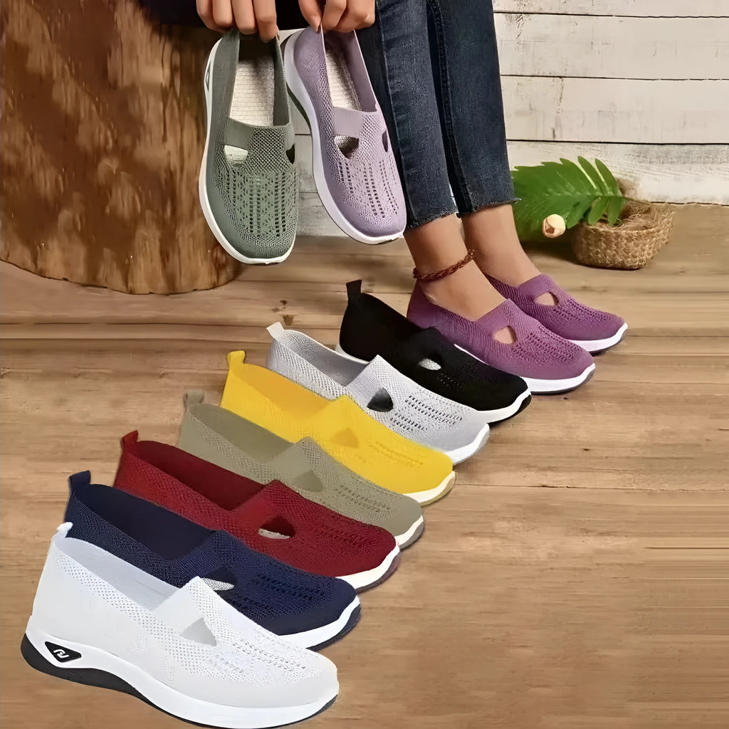 Women's low-top mesh casual flats with a T-strap in various colours on a soft PVC sole.