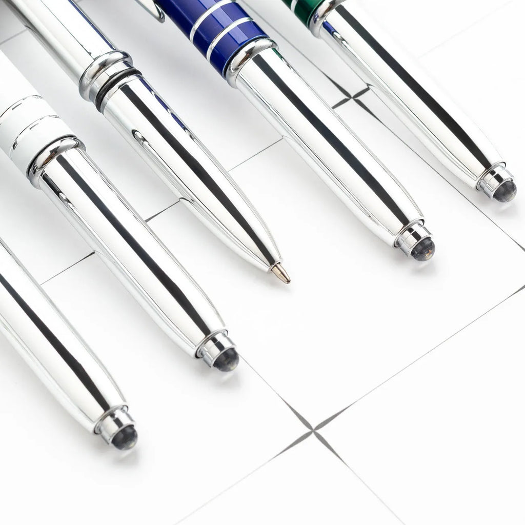 Red metal ballpoint pen with a capacitive stylus tip and built-in LED light on a desk.