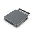 Black Android 8K TV set-top box with remote control, UK plug, and HDMI cable on a wooden surface.
