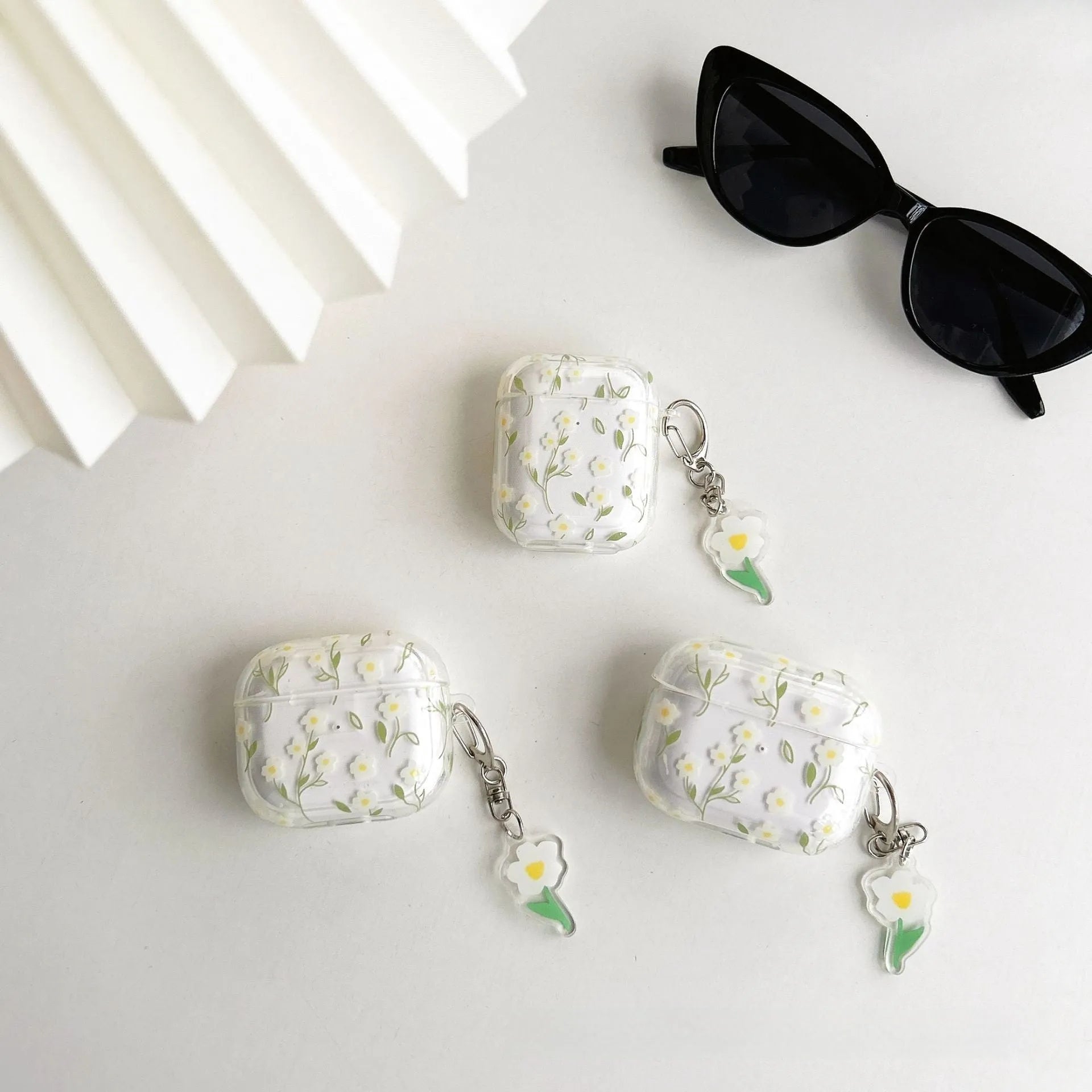 Transparent white floral TPU protective cover for Apple AirPods showing charging port access