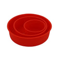 Set of three round red silicone cake moulds in 4-inch, 6-inch, and 8-inch sizes on a baking tray.