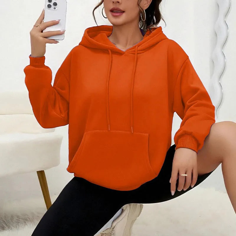 Women's loose grey drawstring hood sweatshirt with a front kangaroo pocket on a hanger.