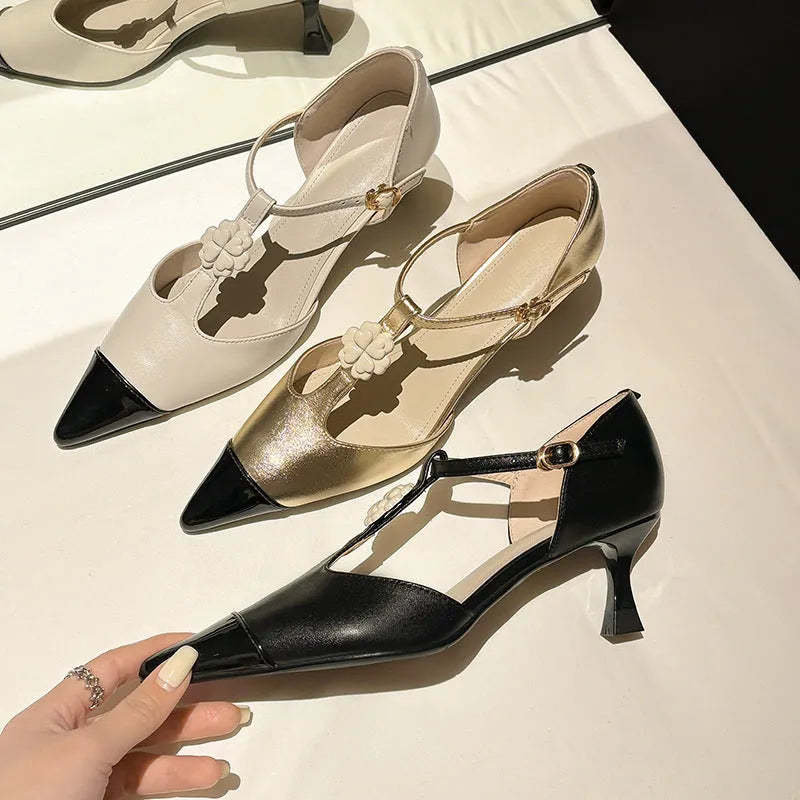 Women's black pointed toe stiletto shoe with flower buckle detail on a sheepskin upper.