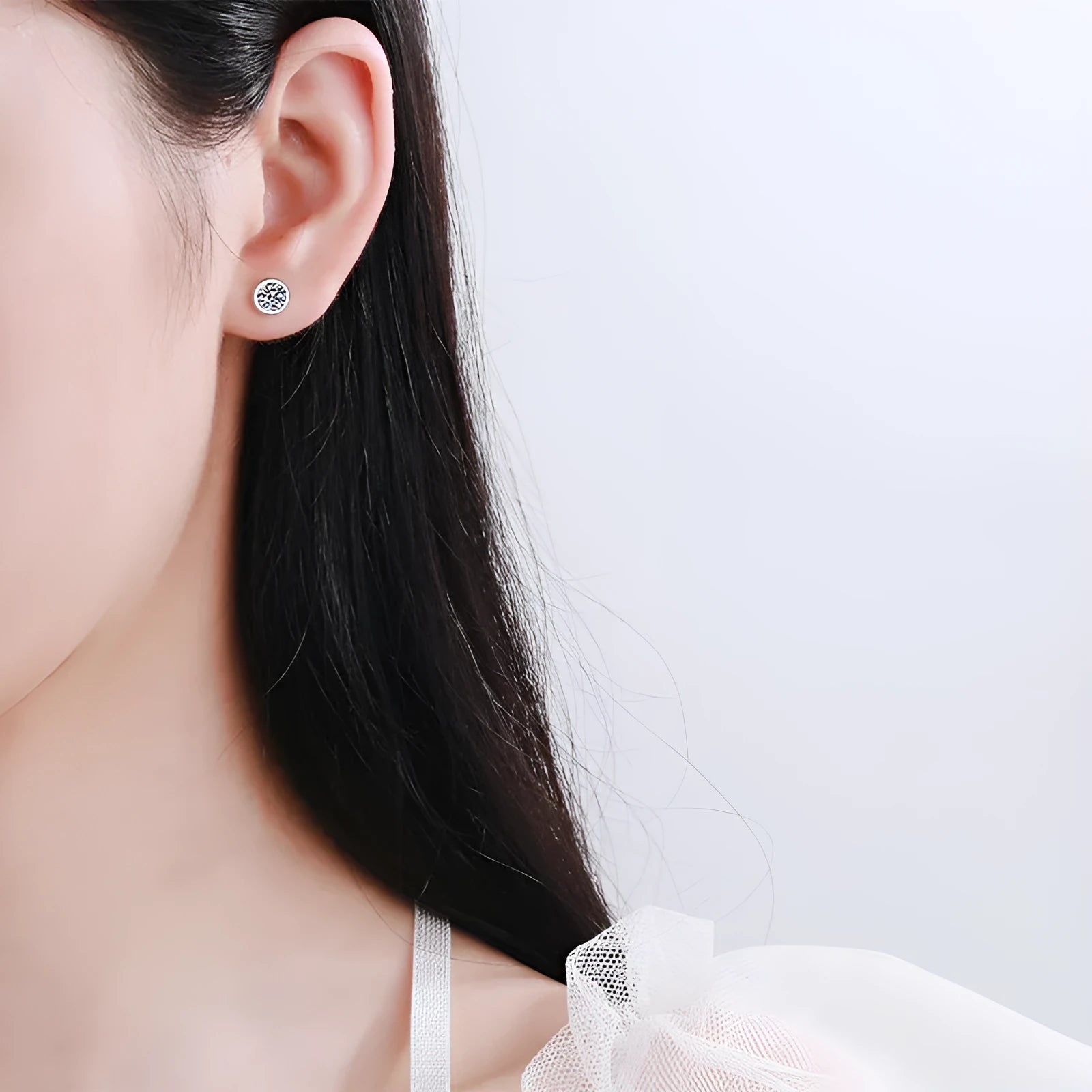 A pair of sterling silver earrings with geometric design and a choice of moissanite or zircon stone.