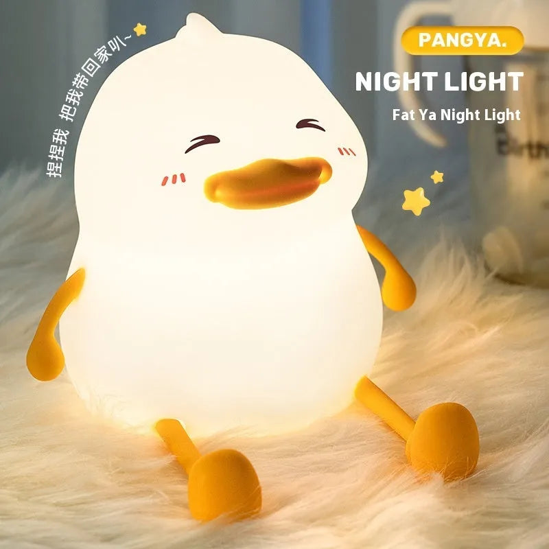 Chubby silicone rechargeable night light on a desk, showing soft glow and touch-sensitive surface.