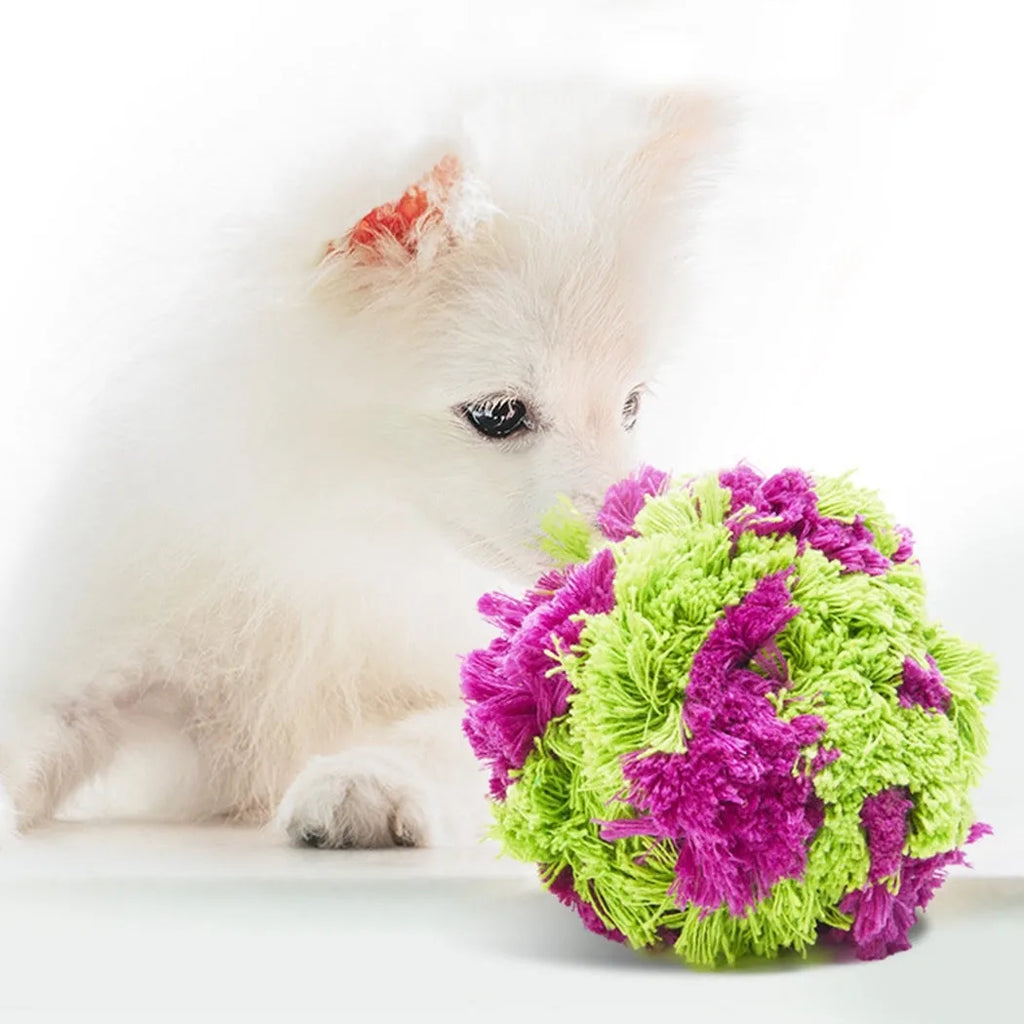 Purple plush dog sea ball chew toy with white knot designs, approximately 15cm diameter