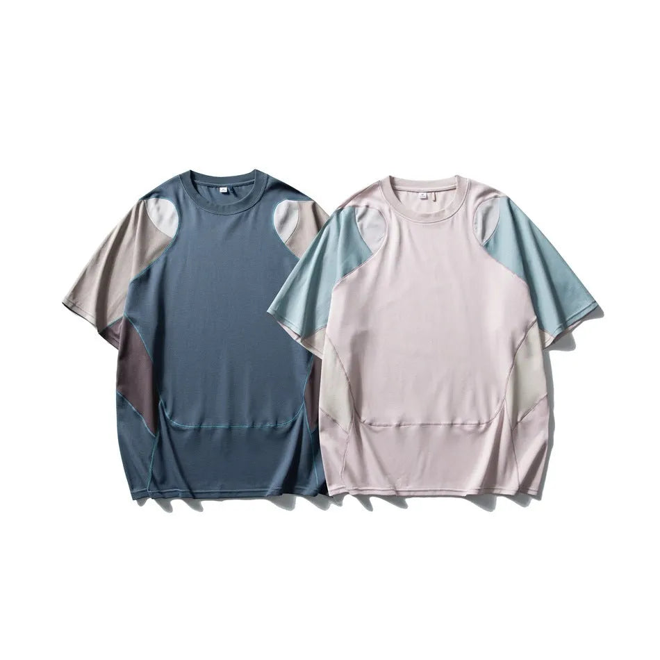 Men's loose blue patchwork t-shirt with raglan short sleeves on a white background.