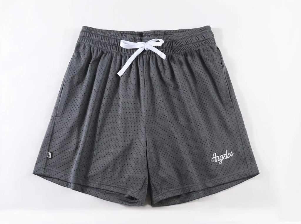 Men's double-layer mesh sports shorts in black polyester fabric showing side profile with elastic waistband