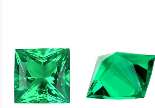Selection of cultivated Columbia green emerald gemstones in various shapes and sizes on a white background.