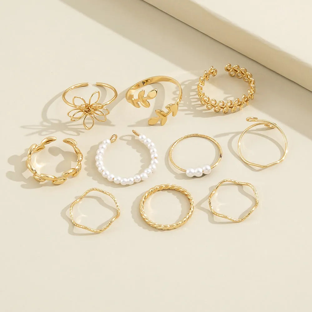 Gold openwork flower ring with alloy construction and electroplated glossy finish