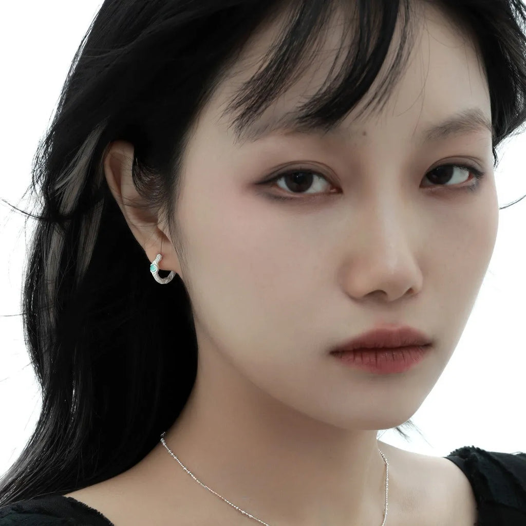 Geometric burnt silver ear clip for women made from 925 silver with round design elements.