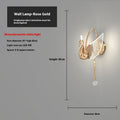 Modern minimalist gold swan-shaped LED wall lamp for bedside lighting.