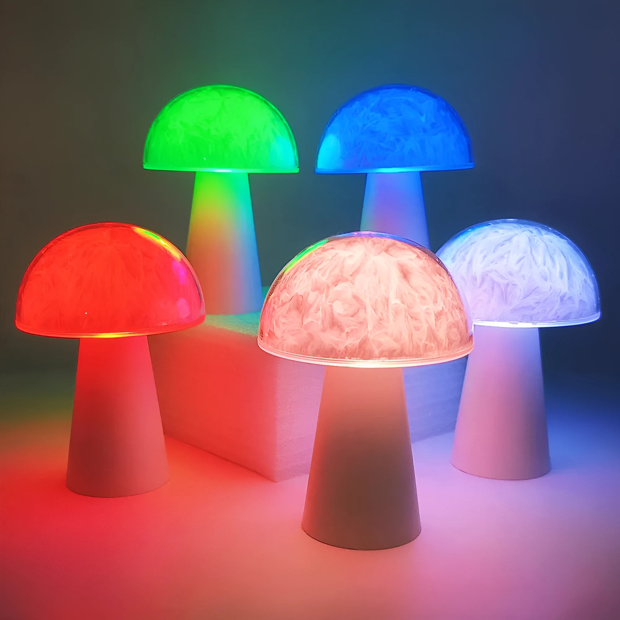 Small white mushroom-shaped night light with remote control on a wooden table.