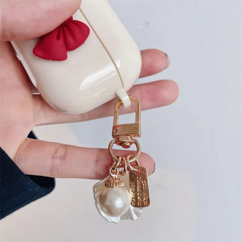 Beige red bow shell pendant TPU case for Apple AirPods wireless earphones with clamshell design