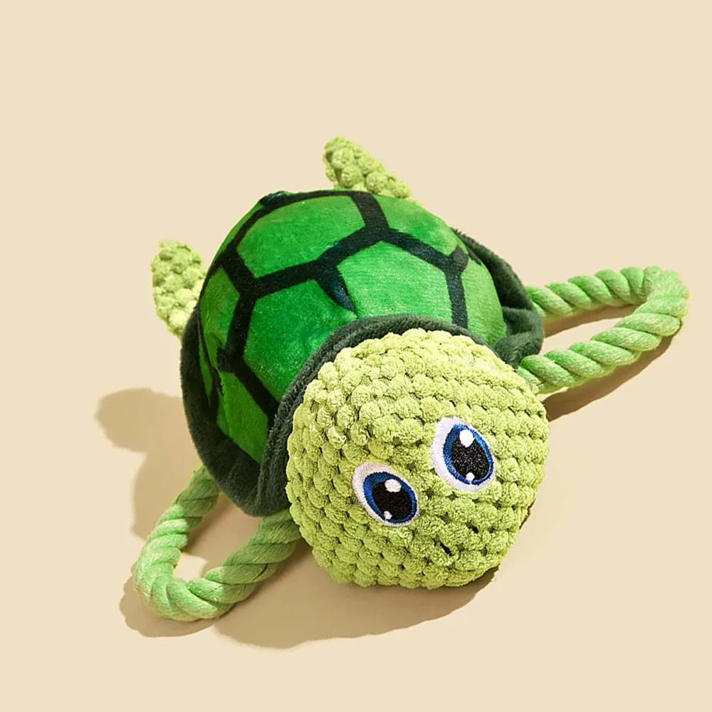 Grey turtle-shaped stuffed dog toy with internal knotted rope for chewing