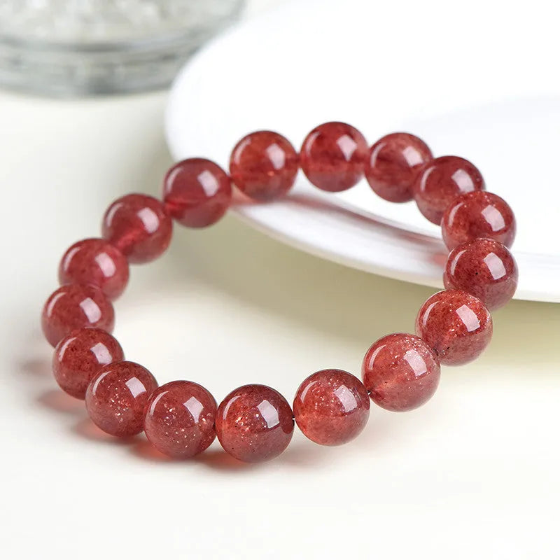 Natural strawberry quartz bracelet showing cherry red colour with starlight effects on geometric beads