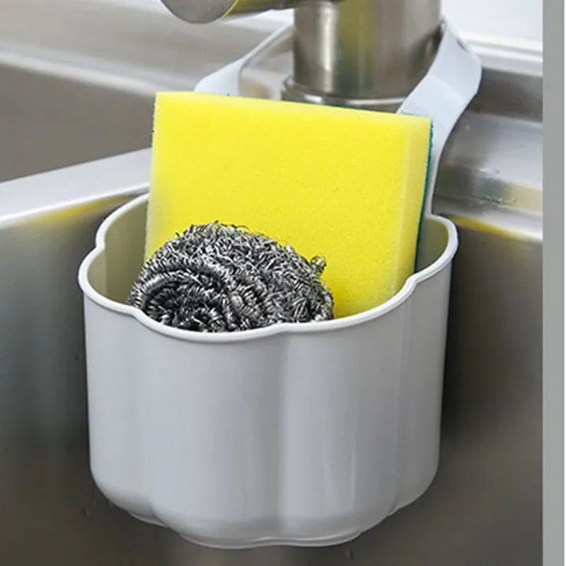 Nordic-style plastic sink drain basket in dark blue on a kitchen countertop.