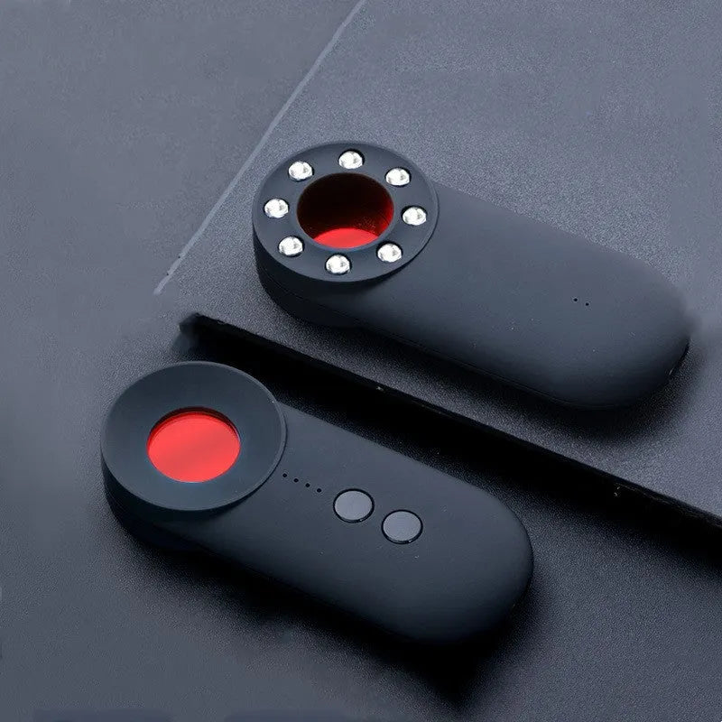 Black portable GPS and hidden camera signal detector showing compact size and Micro USB charging port.