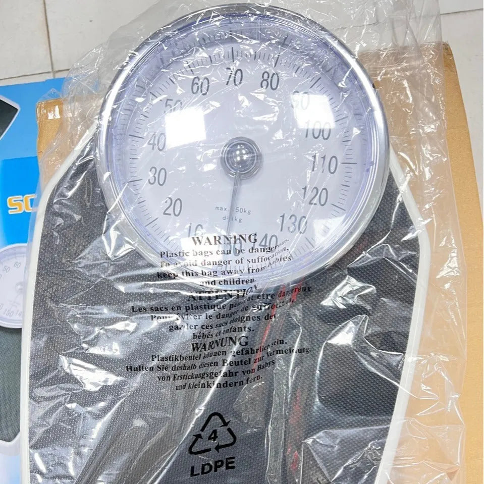Black mechanical bathroom scale with large dial on a 47x35 cm platform.