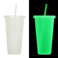 A tall, cylindrical Halloween-themed luminous plastic sippy cup with a straw, showing colour options.