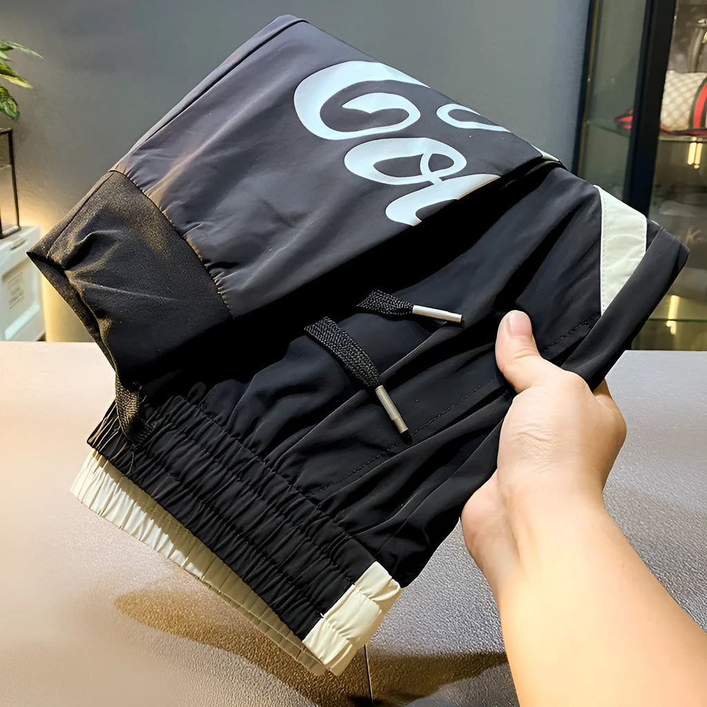 Man modelling black ultra-thin ice silk ankle banded casual cropped trousers.