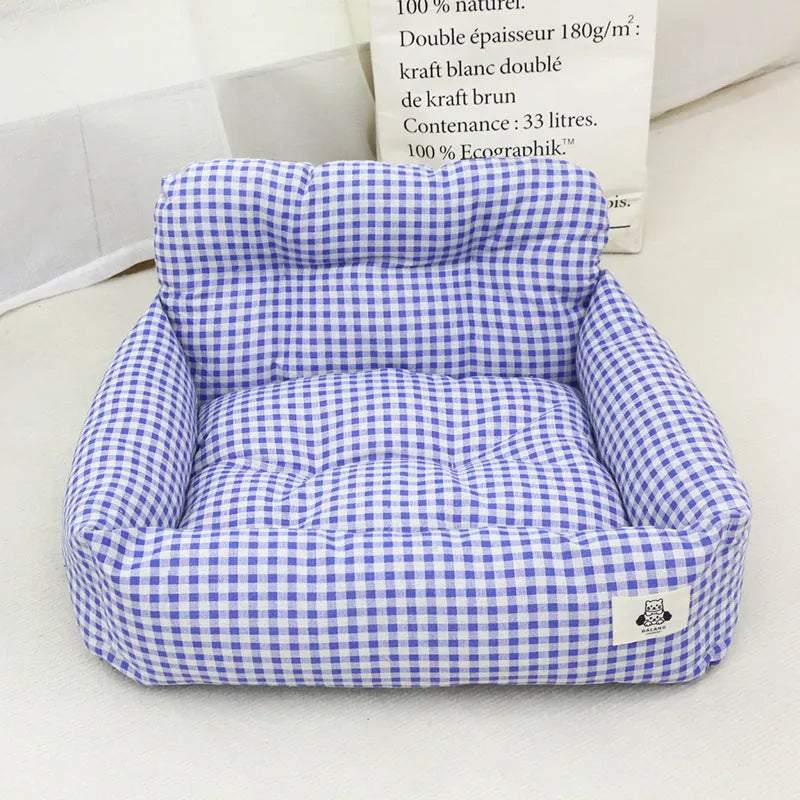 Grey and blue plaid portable dog car travel nest with stain-resistant cloth fabric.