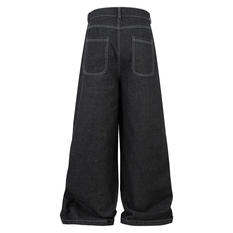 Black pleated denim jeans with multiple pockets, shown on a hanger.