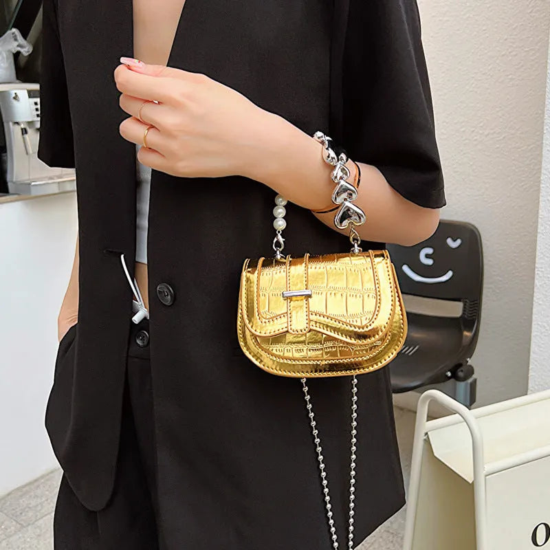 Laser pearl tote saddle girl mini crossbody bag in a horizontal square shape, shown in silver colour.