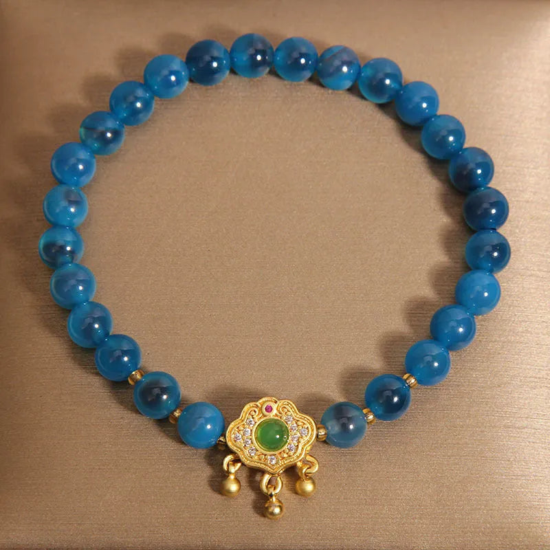 Women's blue sugar heart agate safety lock pendant bracelet with crystal and rhinestone details on alloy.