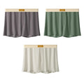 Men's solid colour loose ice silk underwear in beige apricot, laid flat.