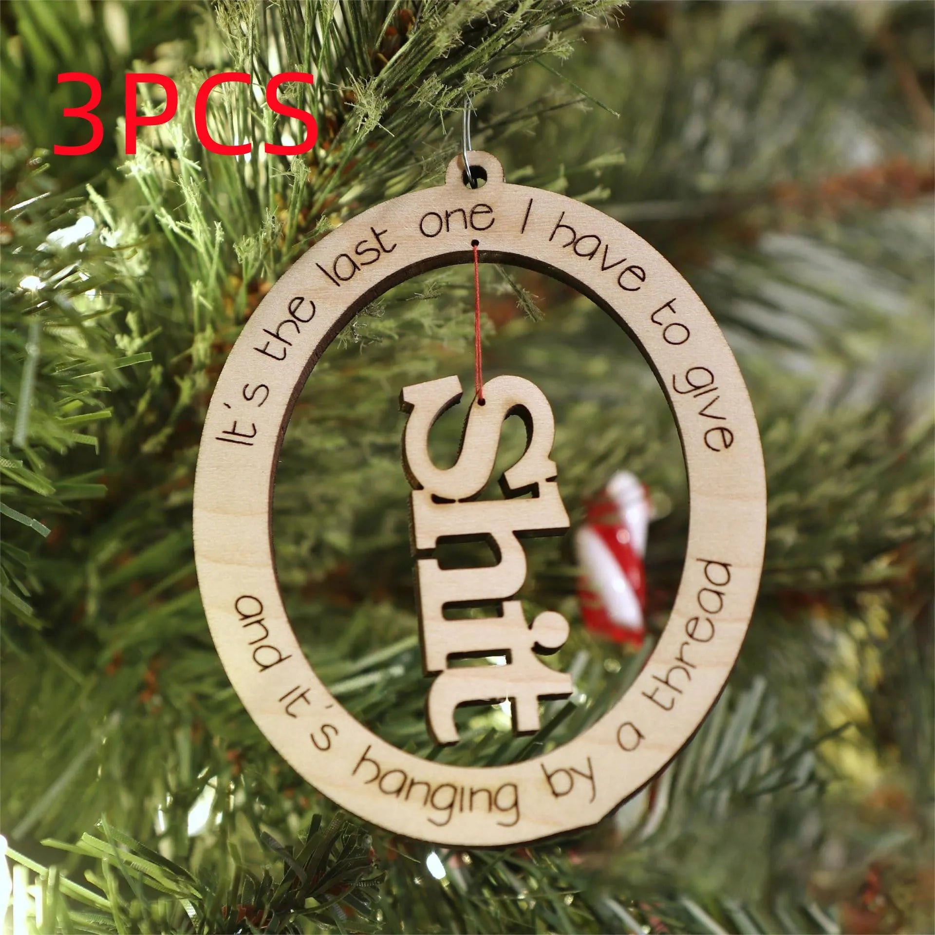 Basswood Christmas tree pendant in colour finish, 9.6x7.7cm, on a tree branch