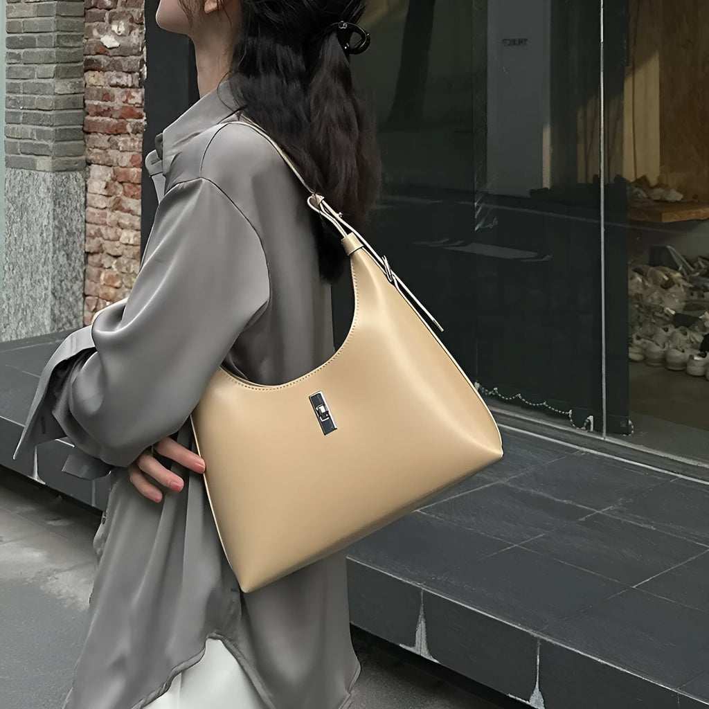 Soft genuine leather dumpling-shaped crossbody bag in apricot colour with visible stitching.