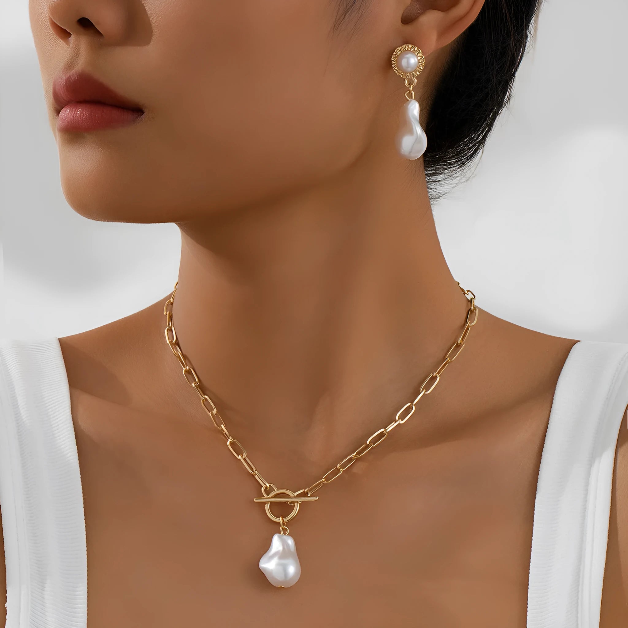 Gold tone retro baroque pearl necklace and matching ear stud set for women.