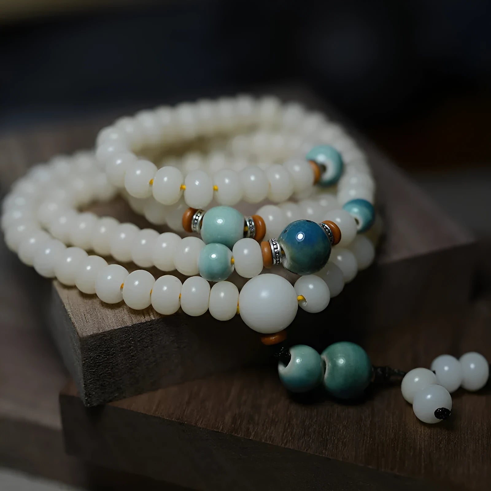 White Jade Bodhi Root Oblate Bead Bracelet with 108 flat round beads on a wrist.