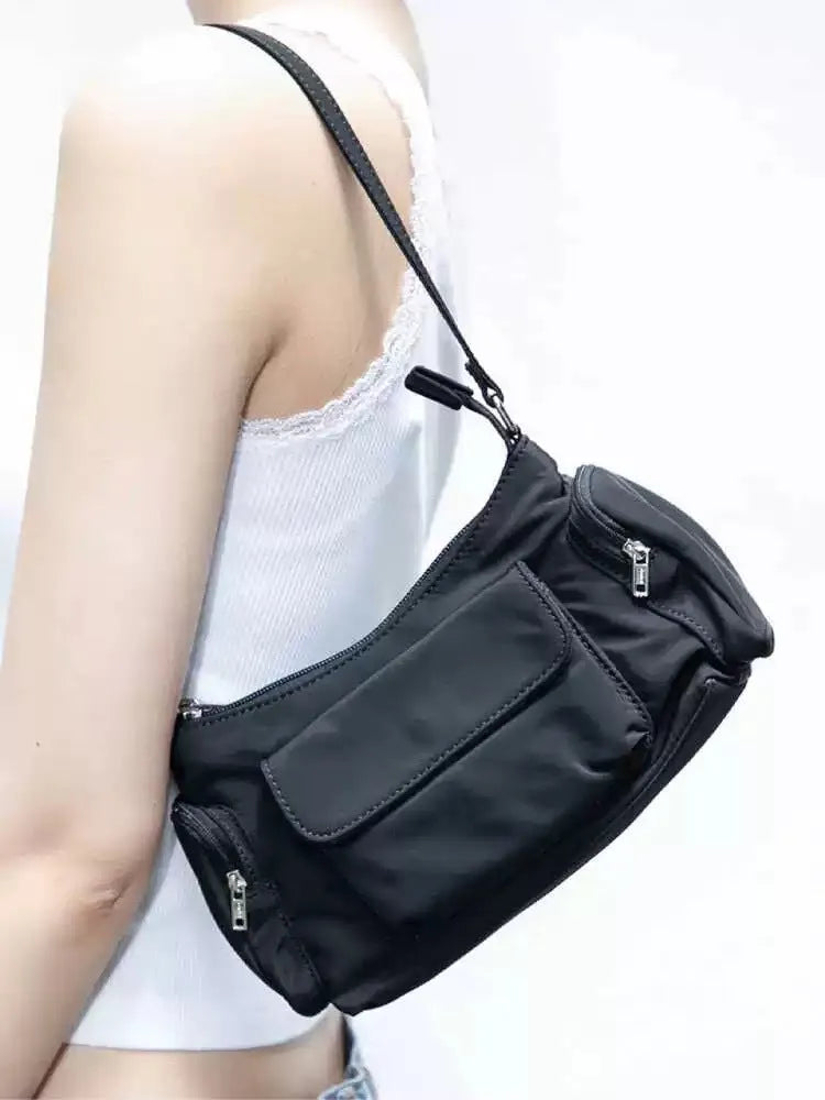 Black PU leather women's shoulder bag with side line detail and double interior pockets.
