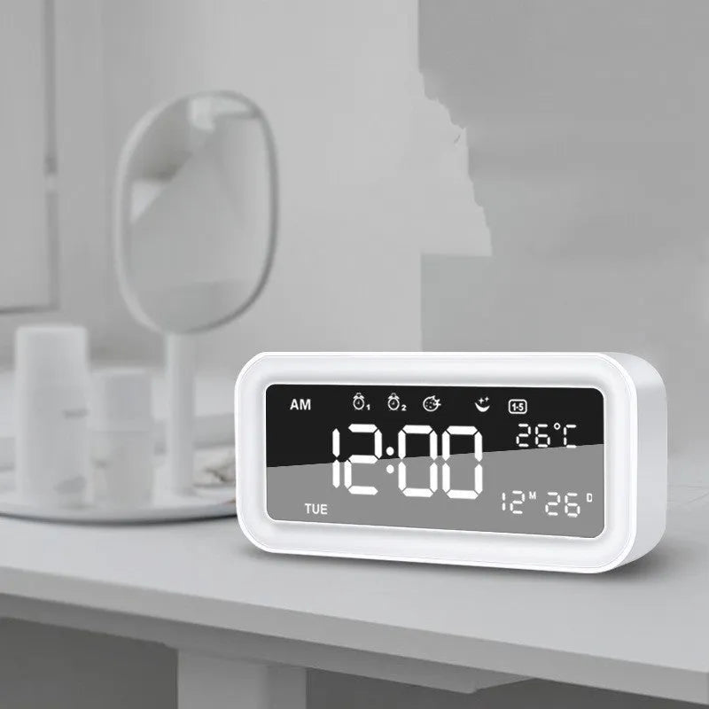 Blue rectangular LED atmosphere light alarm clock with digital display on a table.