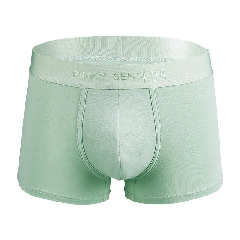 Men's solid colour cotton boxer shorts in black, white, grey, and light green.