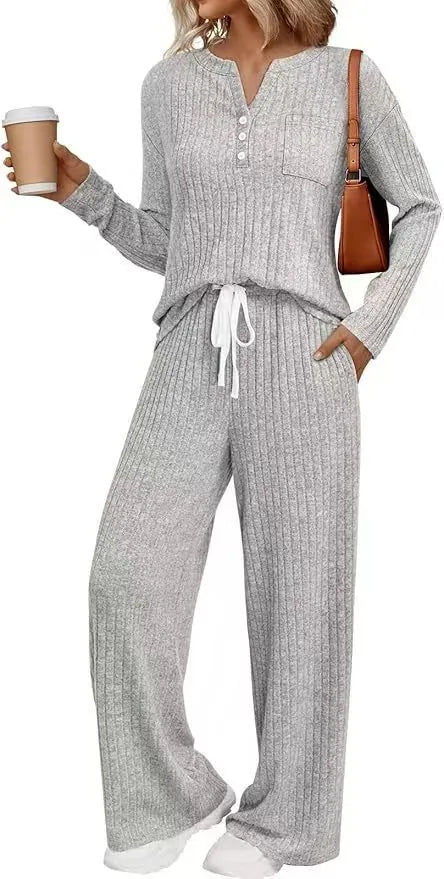 Knitted V-neck striped long coat with long sleeves, pockets, and a lace-up detail on a hanger.