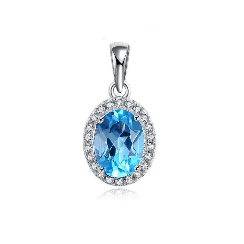 A four-piece women's sterling silver jewellery set with blue topaz gems, showing geometric earrings, ring, pendant, and necklace.