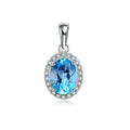 A four-piece women's sterling silver jewellery set with blue topaz gems, showing geometric earrings, ring, pendant, and necklace.