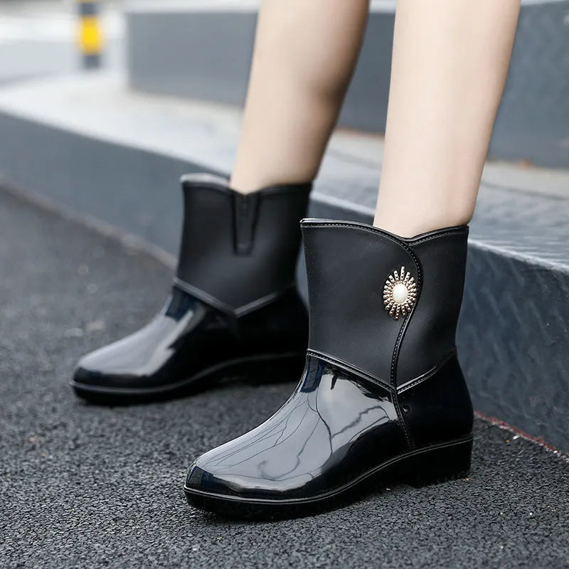 Women's mid-calf PVC rain boots in purple, black, or beige with a non-slip sole.