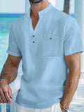 Man wearing a light-coloured linen stand collar short sleeve shirt in a loose fit.