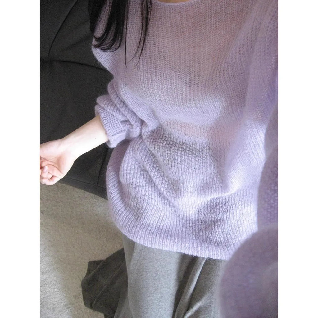 Purple women's blouse with hollow out design and sleeveless princess sleeves on a hanger.