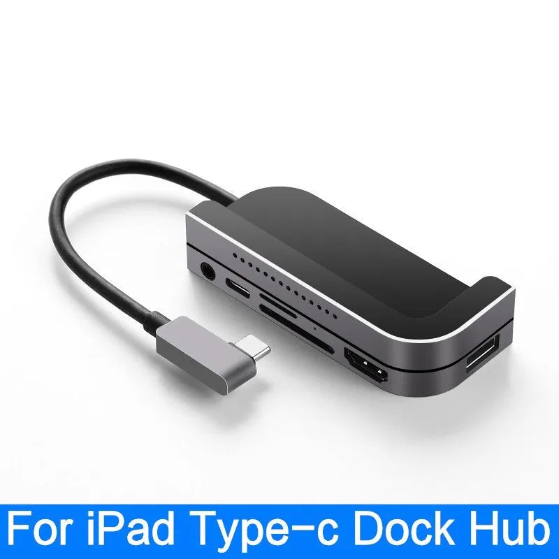 Silver aluminium grey 6-in-1 USB-C docking station for iPad Pro tablets on a desk.